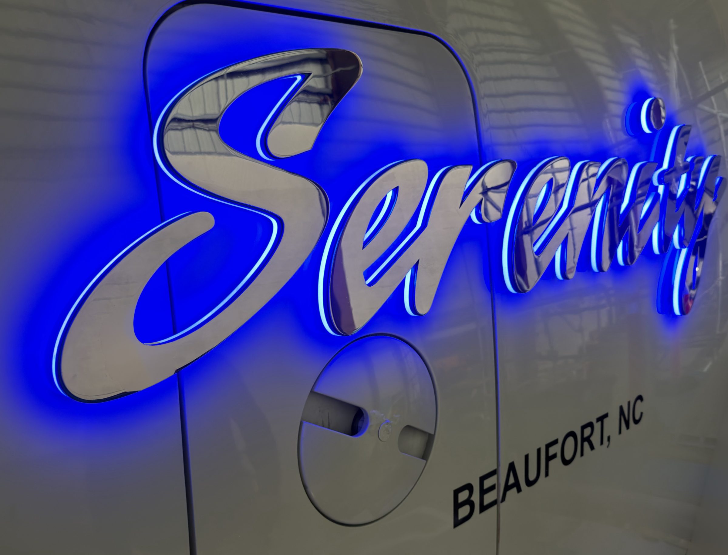Serenity in polished stainless steel script with blue halo lighting, Beaufort, NC